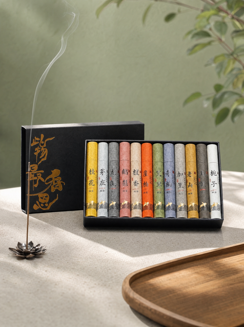 Assorted natural incense box of 12 scents, open, with a burning stick