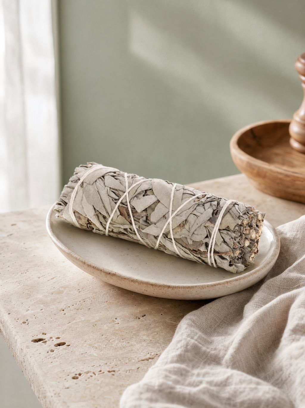 Dried white sage bundle on a ceramic dish